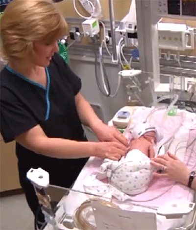 Infant in hospital with nurse