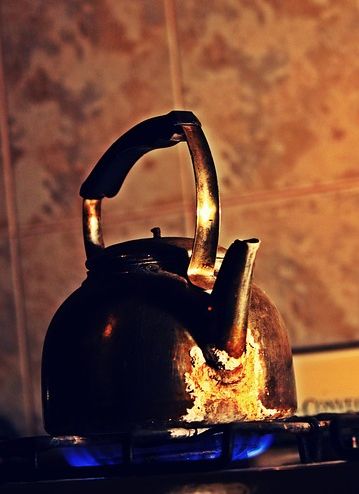 A picture of a kettle on a stove boiling water