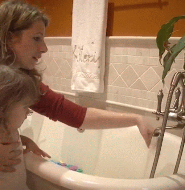 mother and child running hot bath