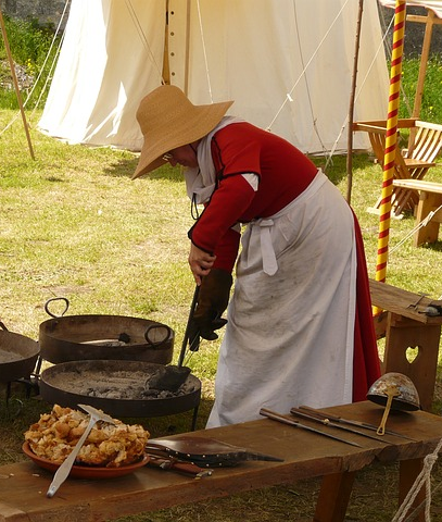 A picture of a woman cooking outside