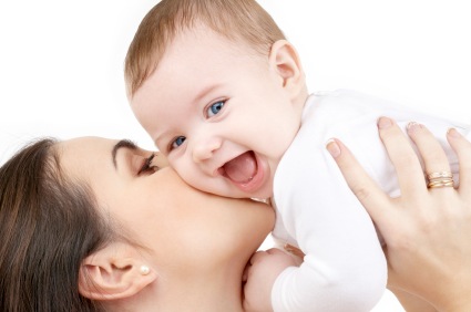 Laughing baby in mom's arms