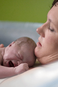 Woman holding newborn after birth
