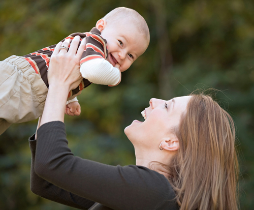 Mom holding baby up in the air