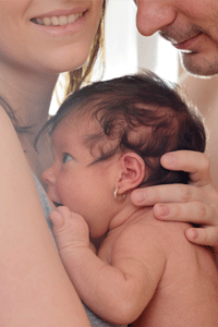 Couple holding baby between them