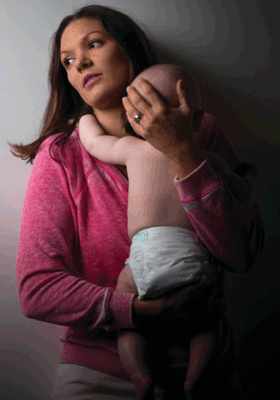 Sad mother holding baby