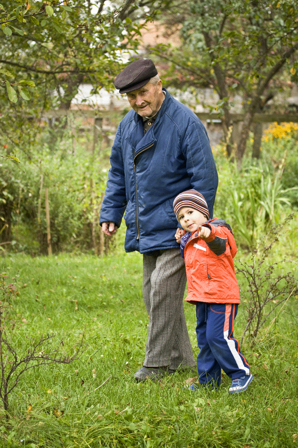 Older man walking with his grandson