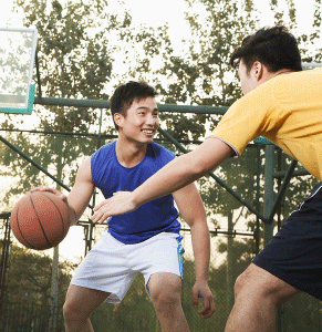 Guys playing basketball