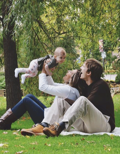 Mom and dad with baby in the park