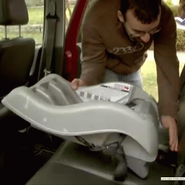 Man installing a car seat
