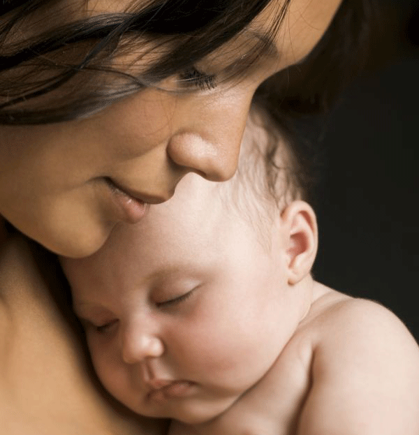 Mother holding her baby skin-to-skin