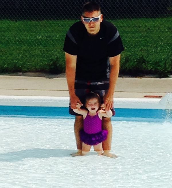 A father and baby in a wading pool