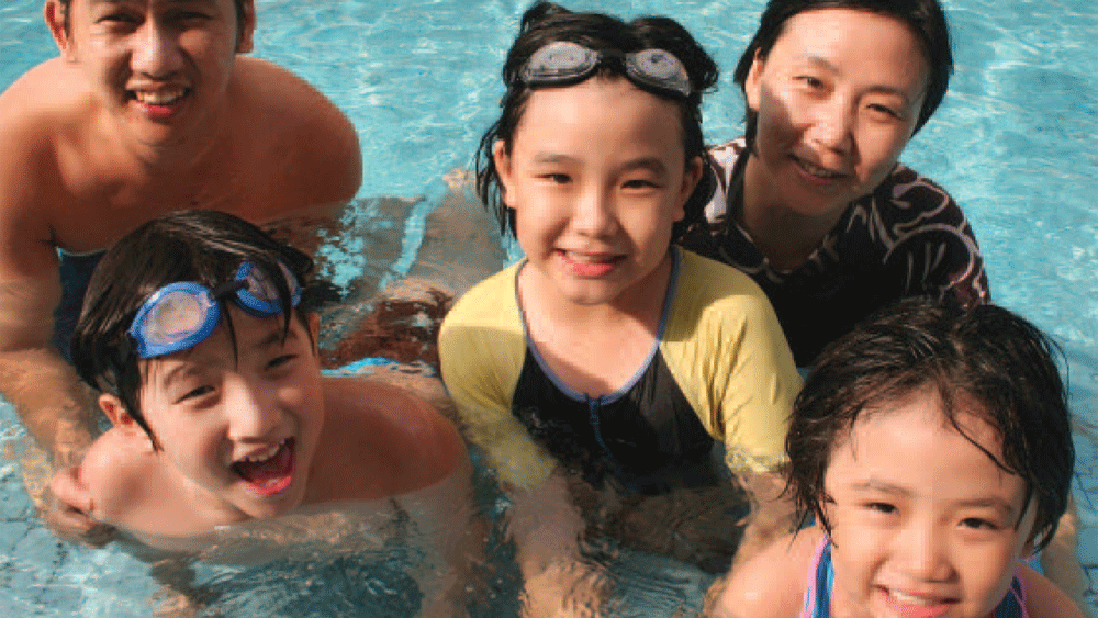 Family with young children in a pool