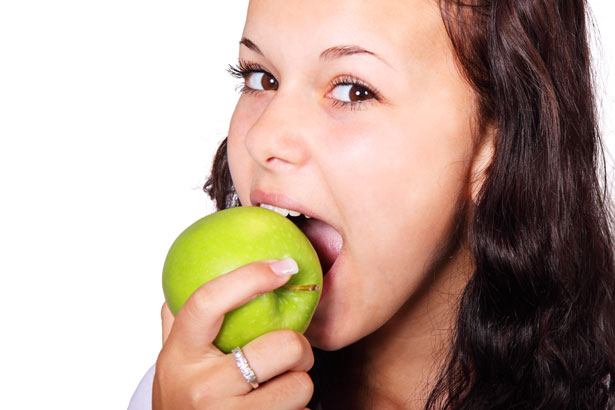Woman eating an apple.