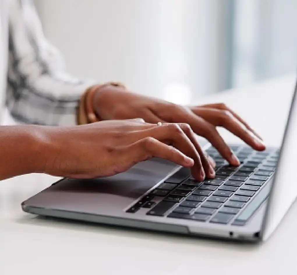 person typing on laptop