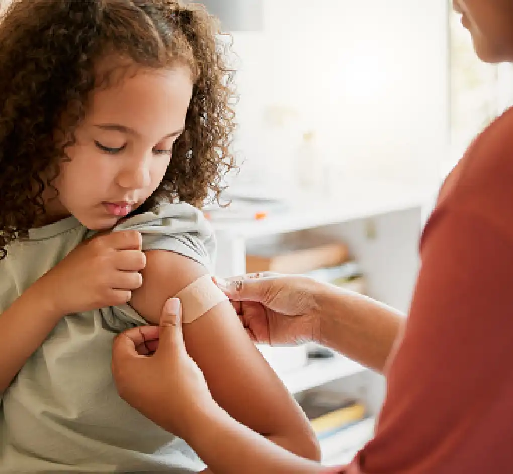 child receiving immunization shot by healthcare provider