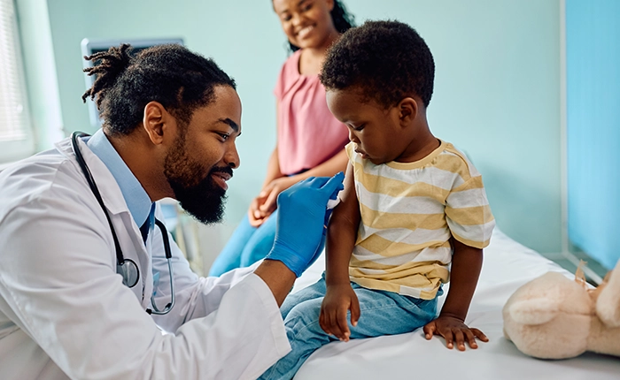 Healthcare provider giving immunization shot to child