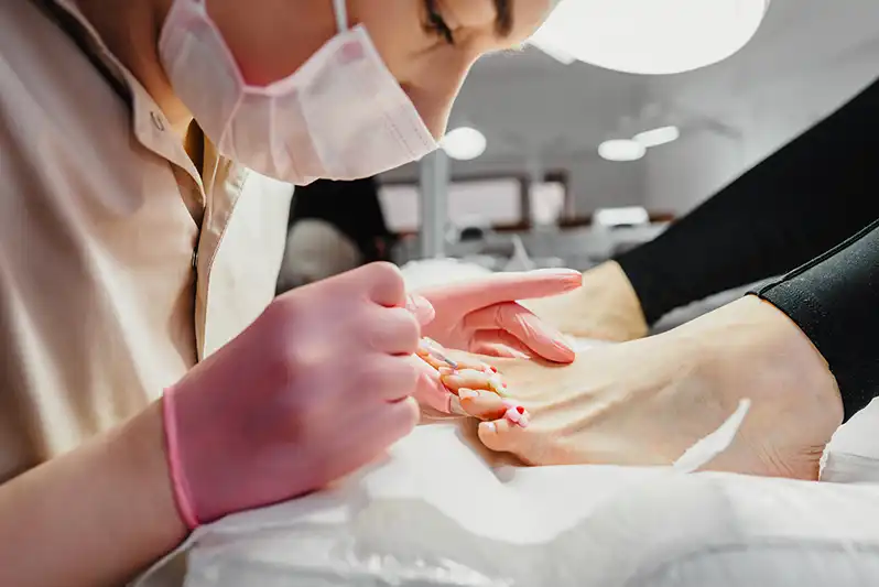 professional taking care of women feet nails