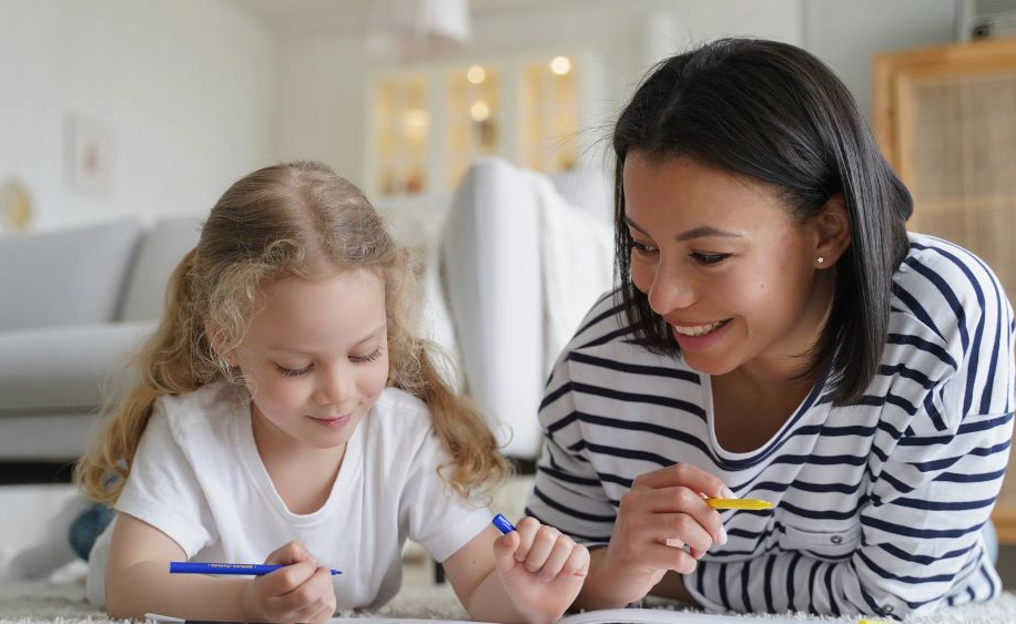 Parent and child drawing together and having fun