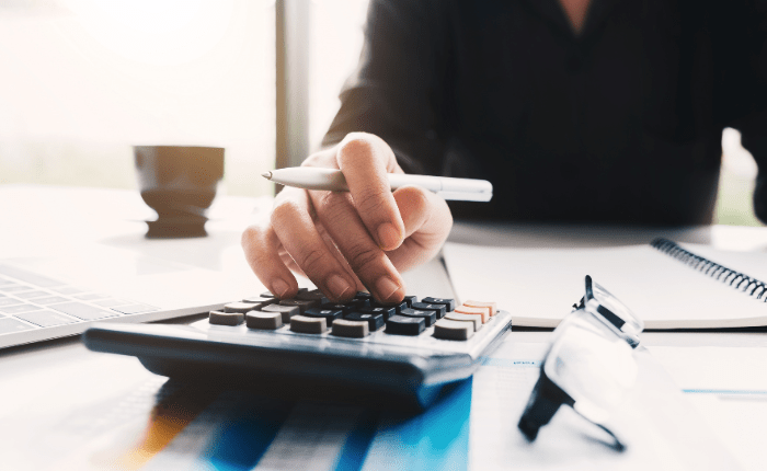 Person working on a calculator.